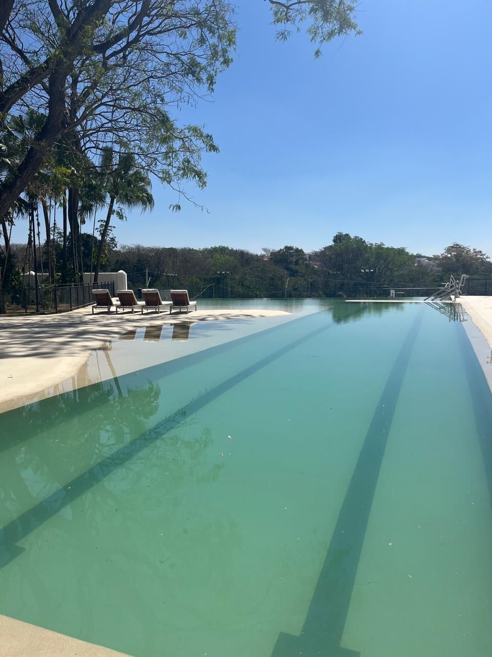 Foto da piscina do clube do Alphaville Dom Pedro 0, com raia e espreguiçadeiras
